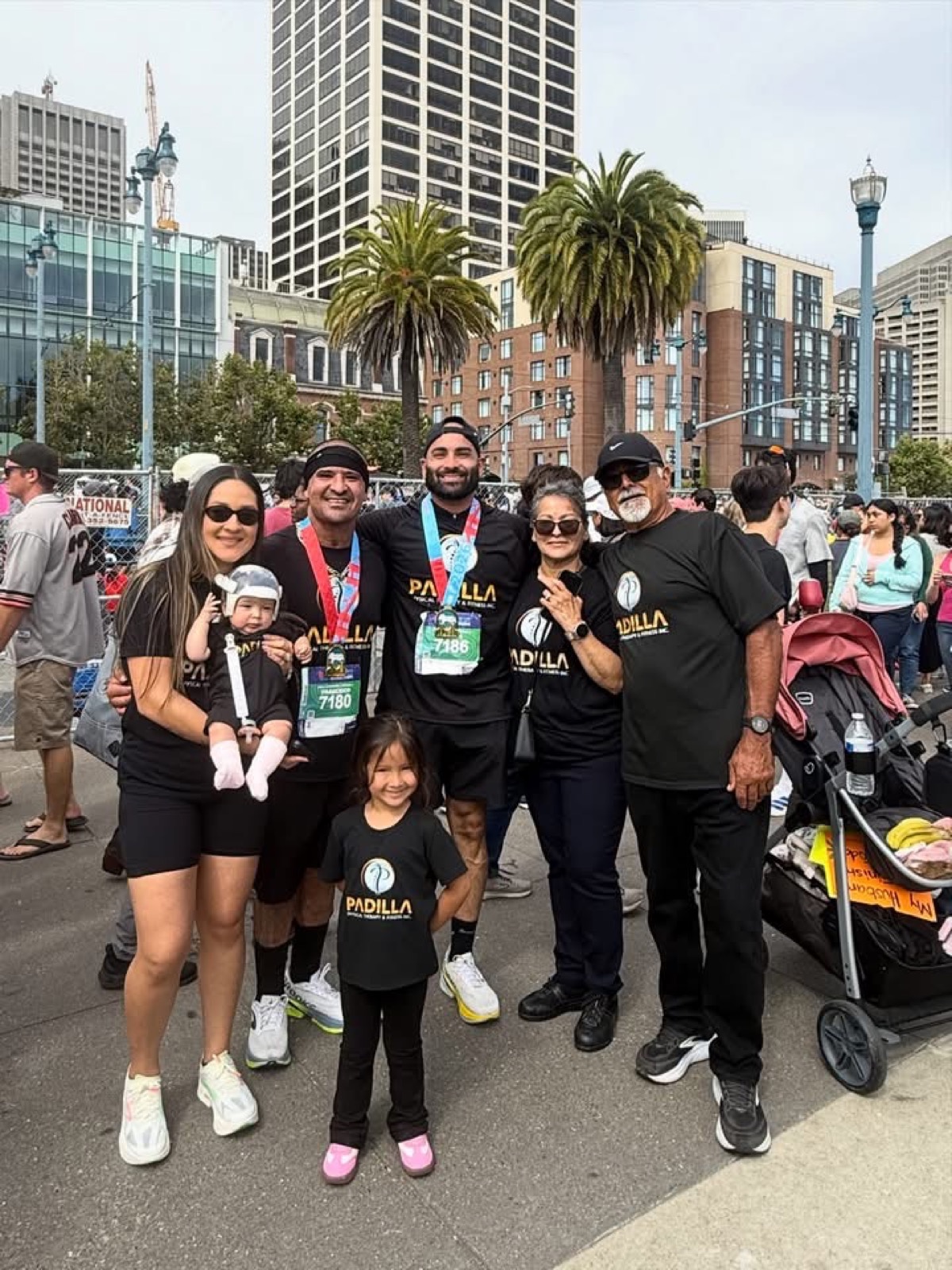 Padilla Physical Therapy team and family at a community run event wearing Padilla shirts